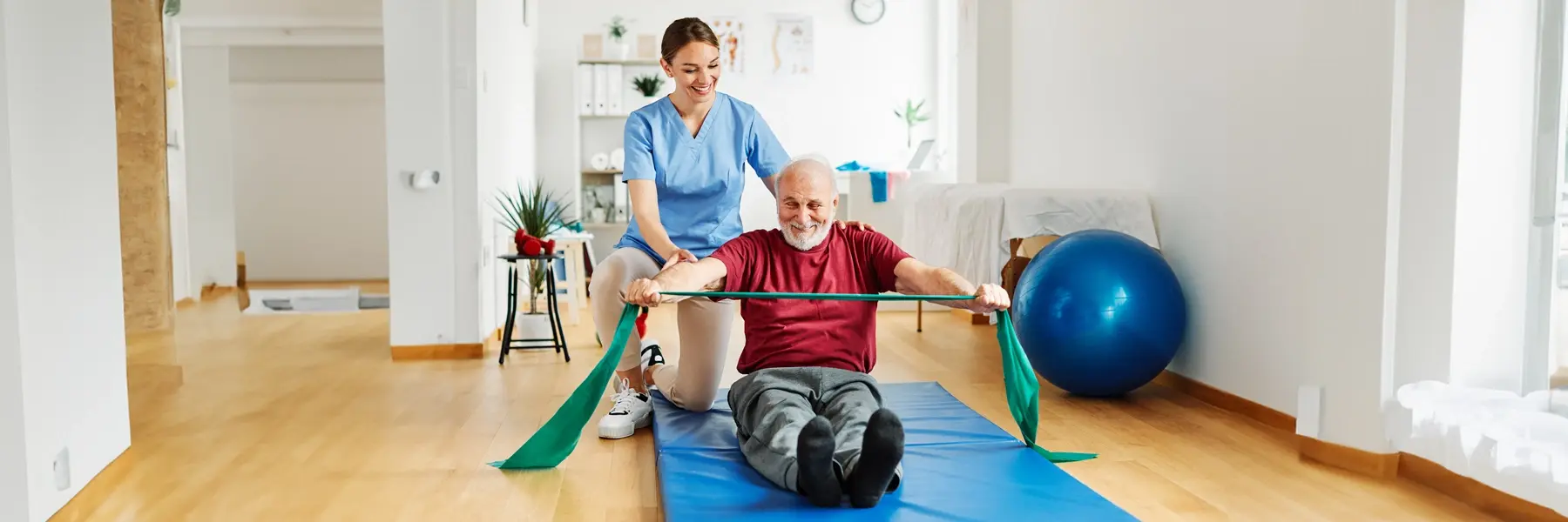 a woman helping a man with a stretch band