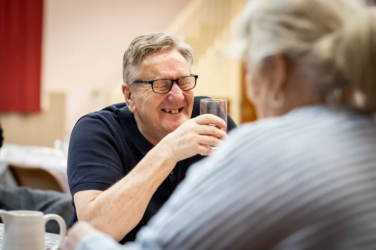 Happy older man laughing warmly - adult speech therapy patient