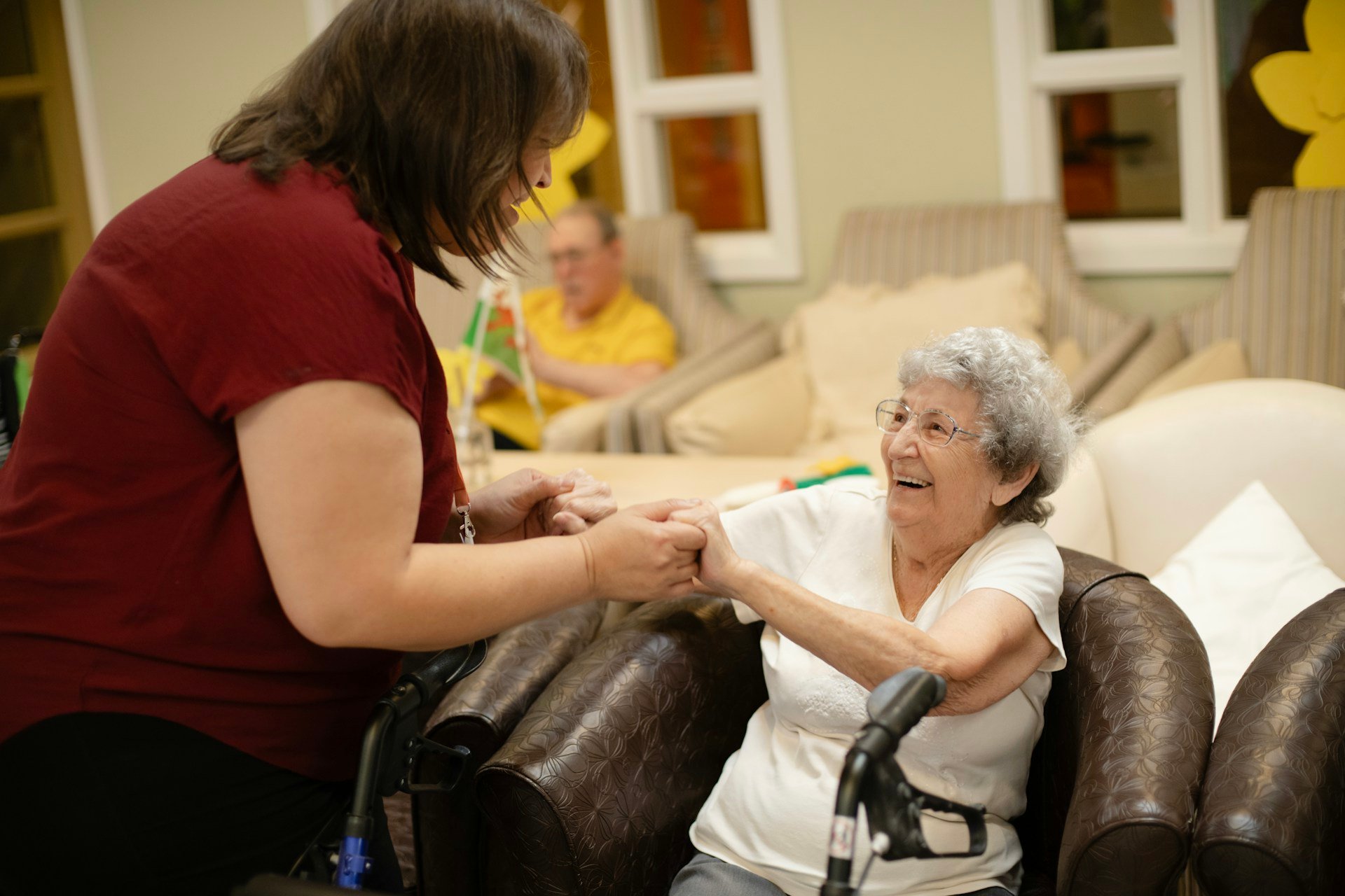 Support worker helping a smiling older Australian woman at home, showing aged care funding support in action