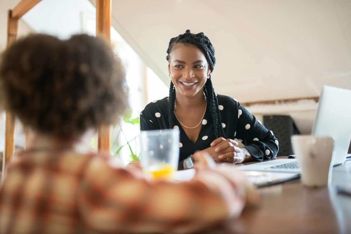 Therapist supporting a child with apraxia of speech treatment in a comfortable home environment