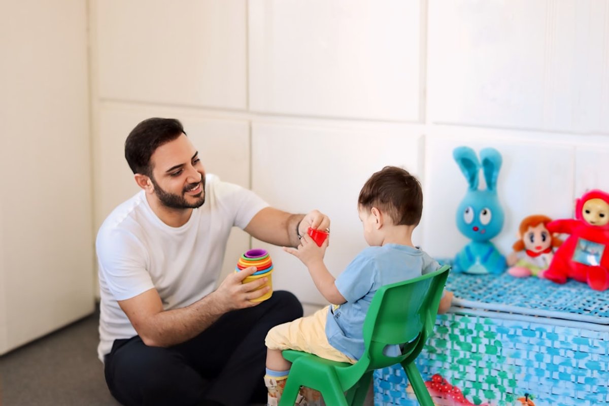 Child receiving apraxia speech therapy during a rehabilitation session with a speech pathologist