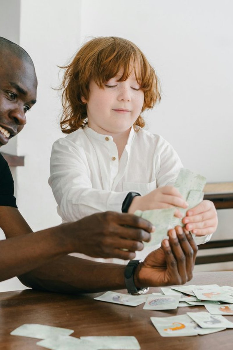 Speech therapist and child working together with picture communication cards during an apraxia therapy session