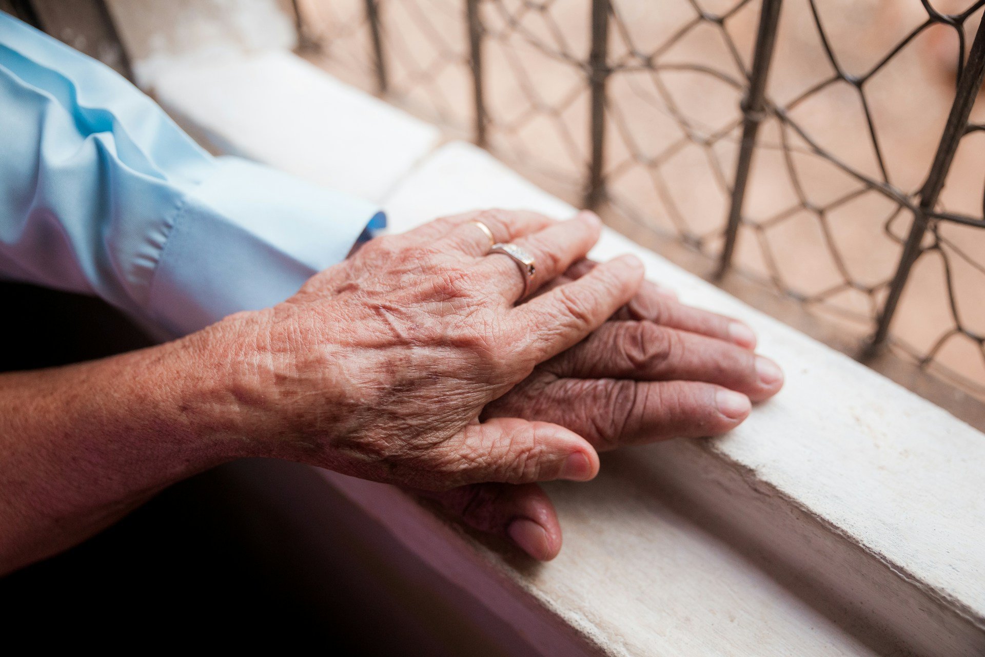 Older adult's hands resting, supported during arthritis occupational therapy