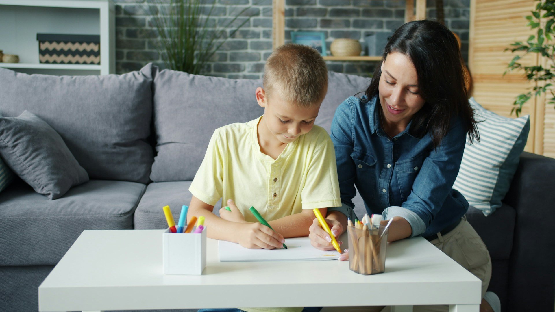 Parent and child working together on a language activity during down syndrome speech therapy