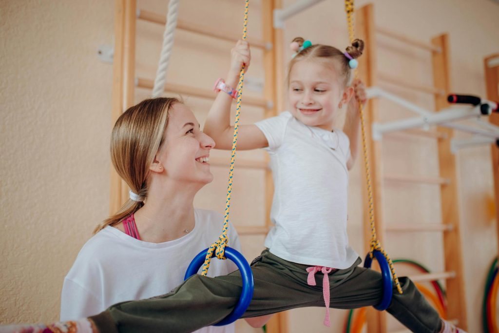 Child practising gross motor coordination and balance activities for dyspraxia therapy