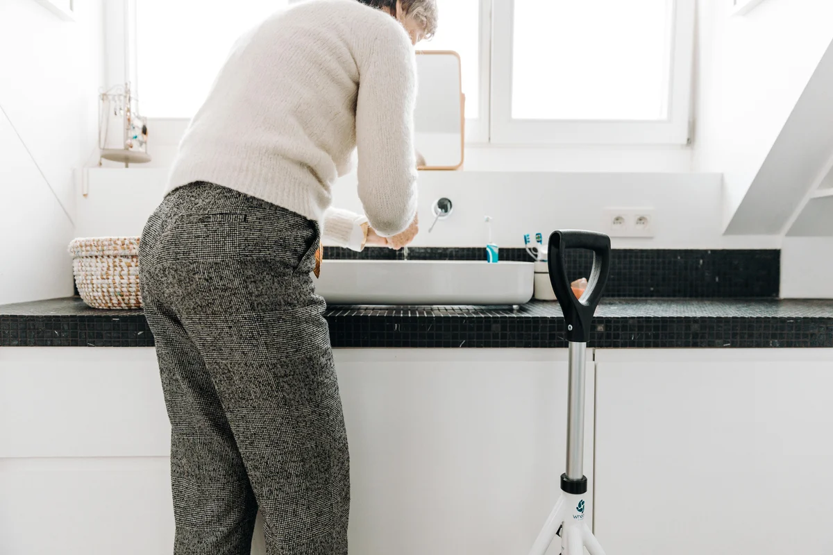 Senior adult in a bathroom demonstrating safe independent movement and home safety for falls prevention