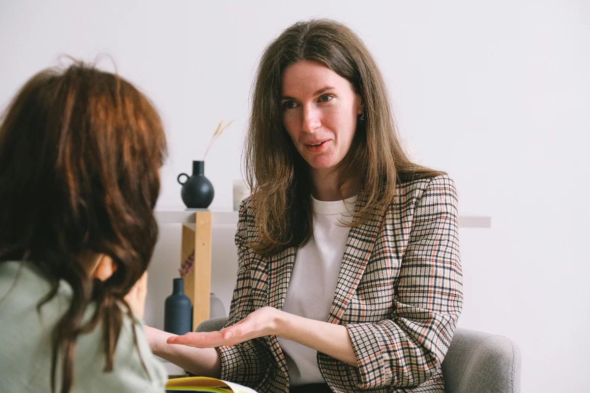 Supportive occupational therapist smiling during a consultation session for intellectual disability therapy in a professional, welcoming environment