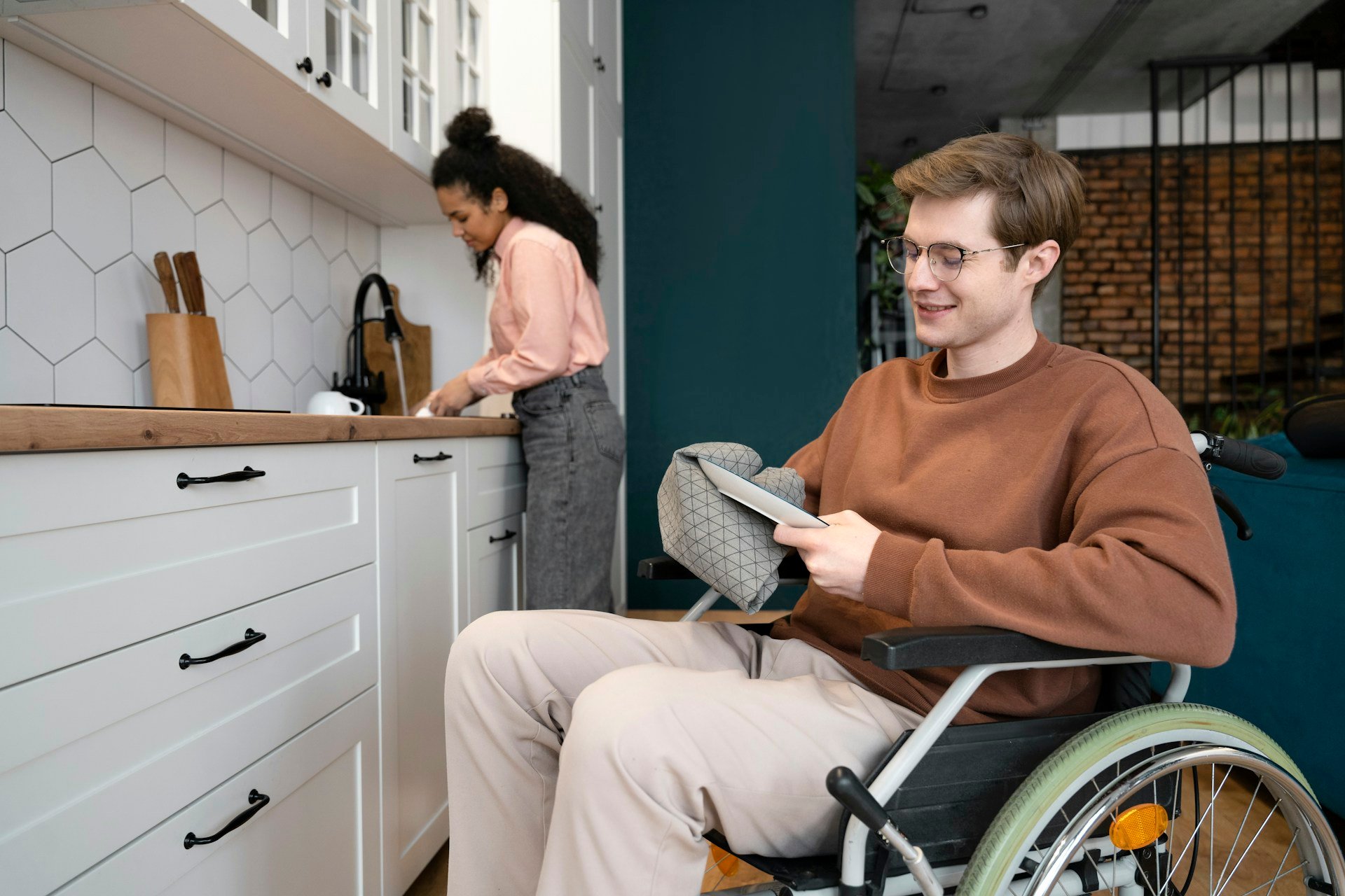 Man using a wheelchair at home after a mobility aids assessment