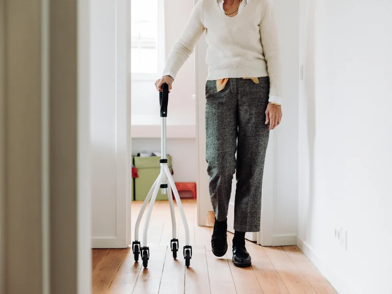 Senior adult using rollator walker as mobility assistive technology