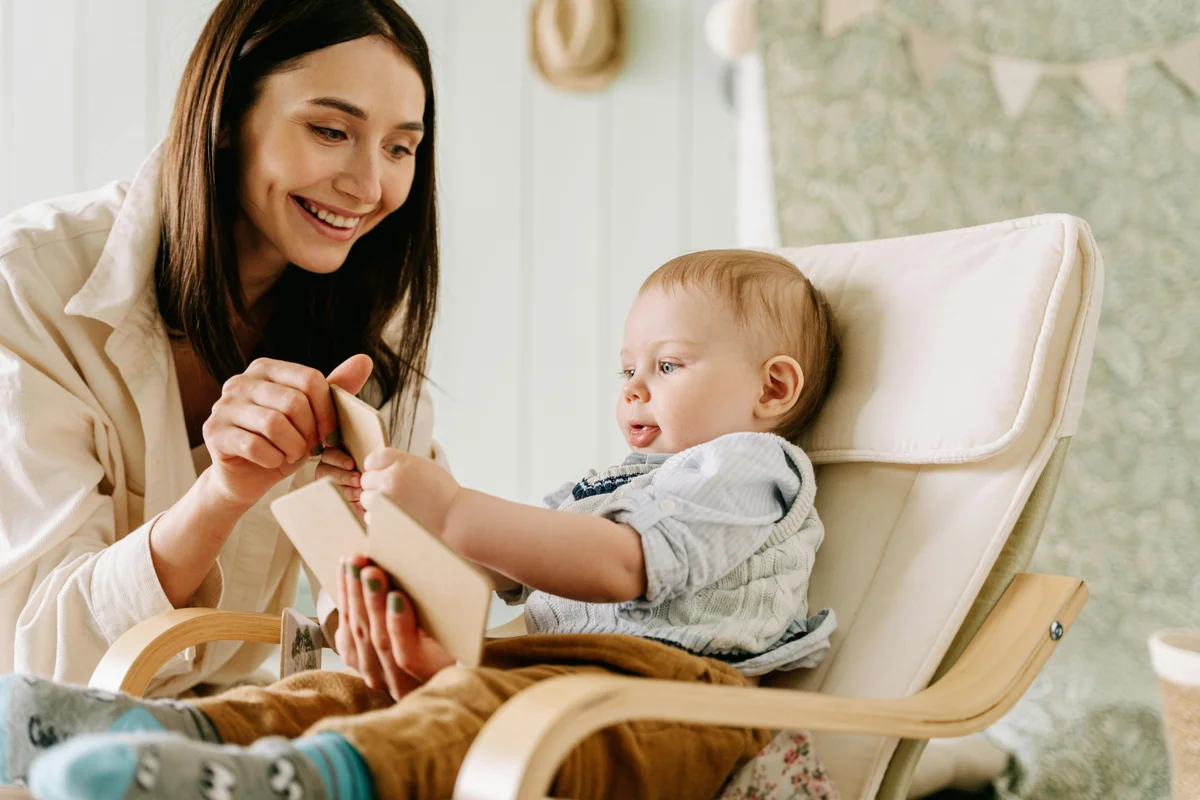 Mother reading a book with her toddler, supporting early language development through shared reading