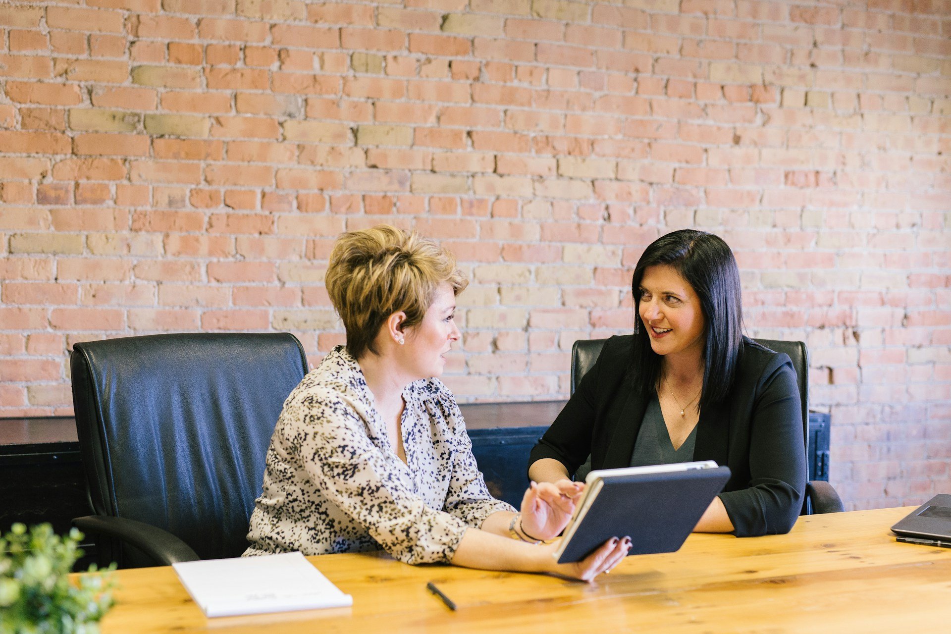 Two women discussing a plan during an NDIS plan review consultation