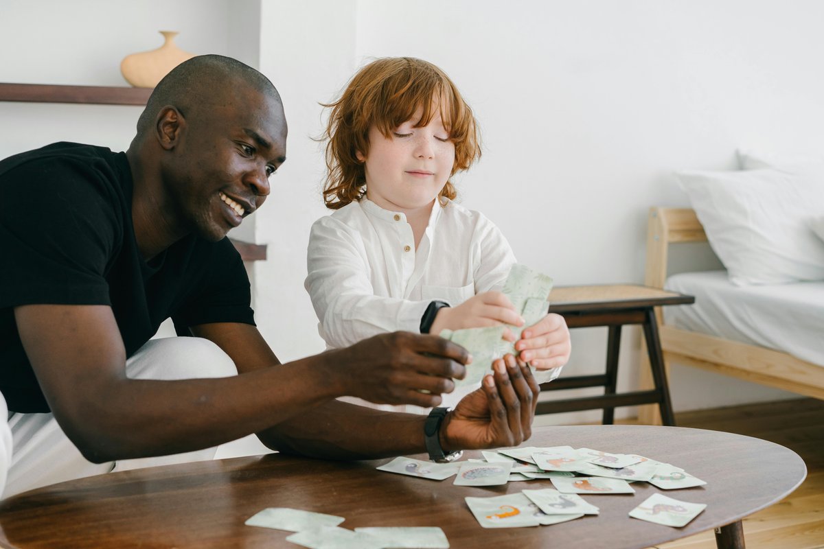 Therapist and child working together with picture communication cards during an NDIS speech pathology session