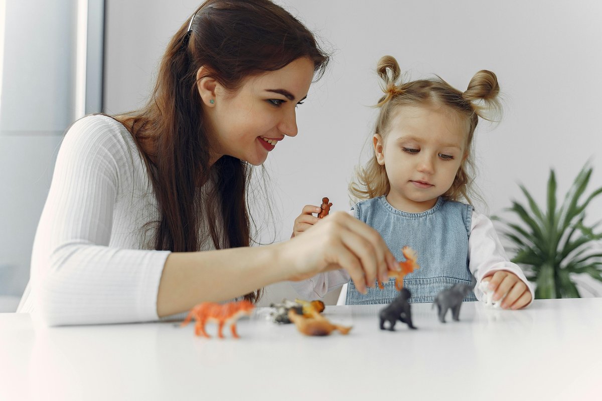 Mother and young child engaged in play-based learning activities to support speech and language development