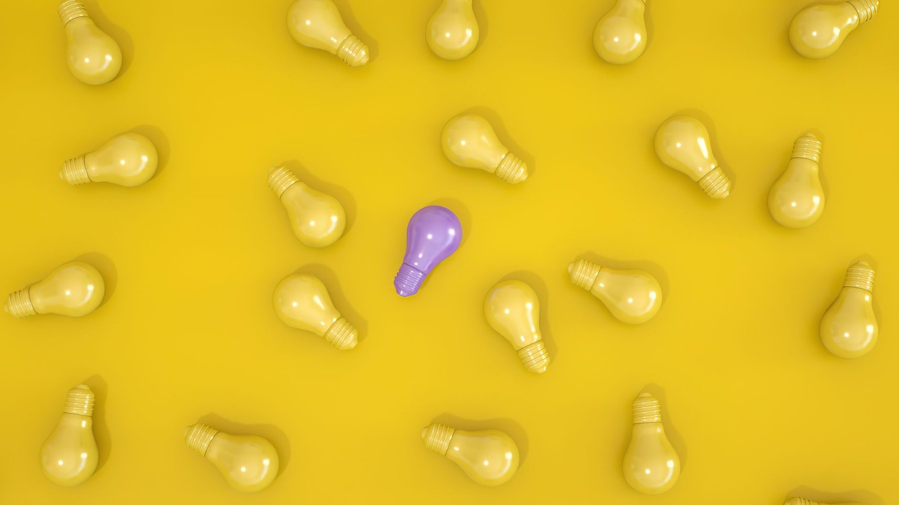 A single purple light bulb among yellow light bulbs on a yellow background, representing neurodivergent thinking and different ways of processing the world