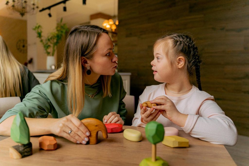 Child with Down syndrome engaging in occupational therapy activities with wooden toys supported by therapist