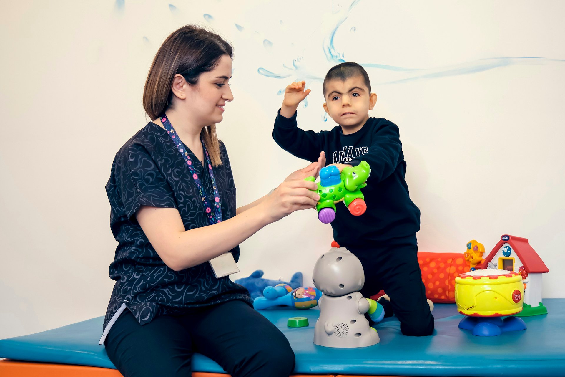 Occupational therapist using toys with a child during a sensory profile assessment