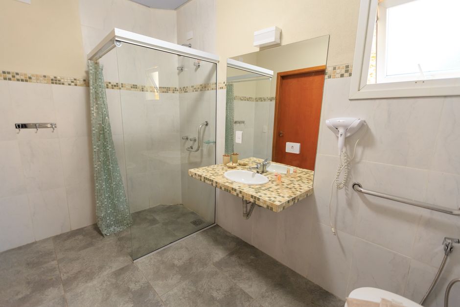 Accessible bathroom in SDA housing with a level access shower, grab rails and room to turn a wheelchair