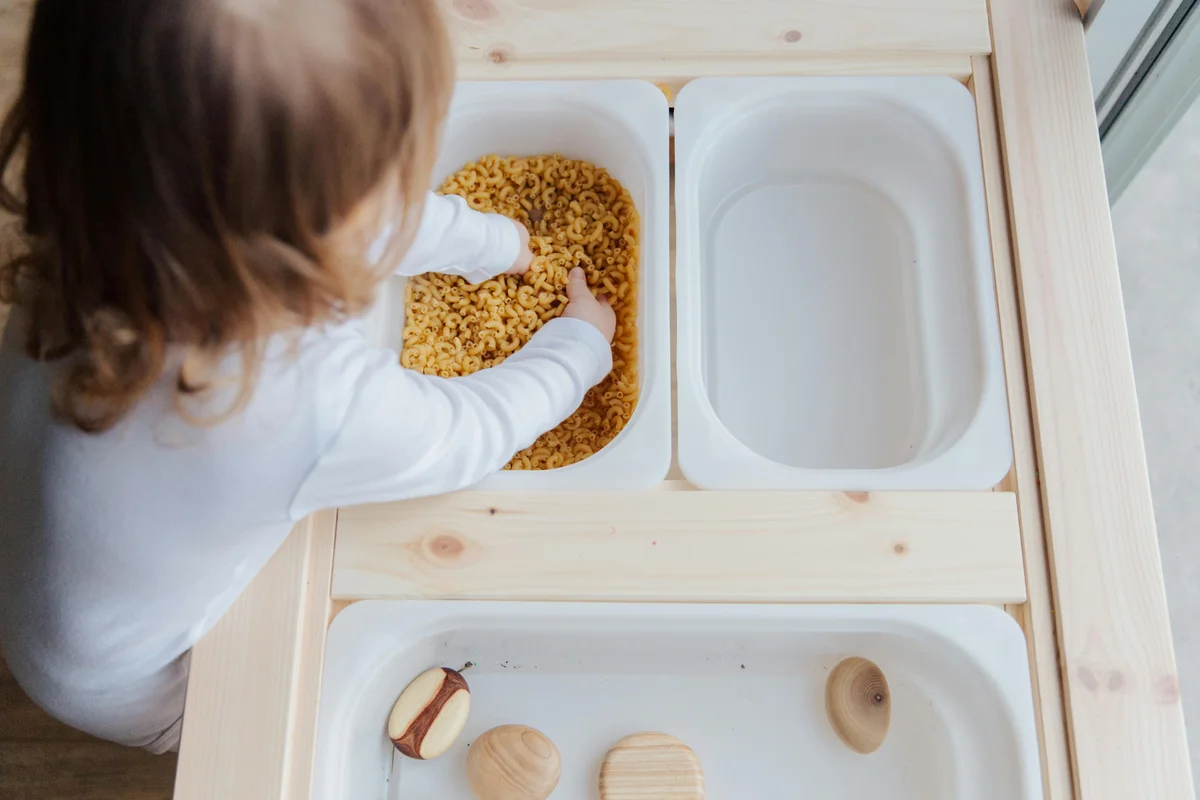 Child exploring textures during sensory processing occupational therapy session
