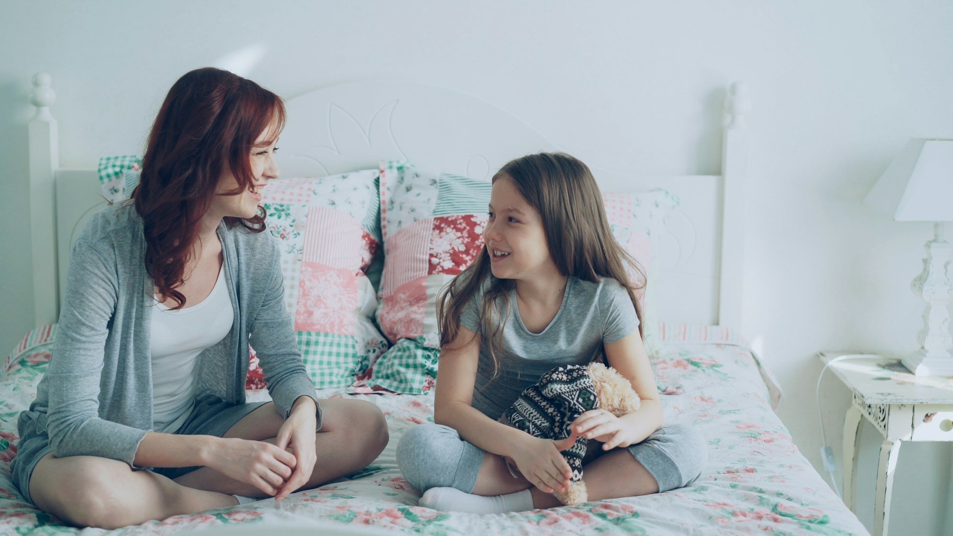 Parent and child smiling and talking together at home during everyday communication practice