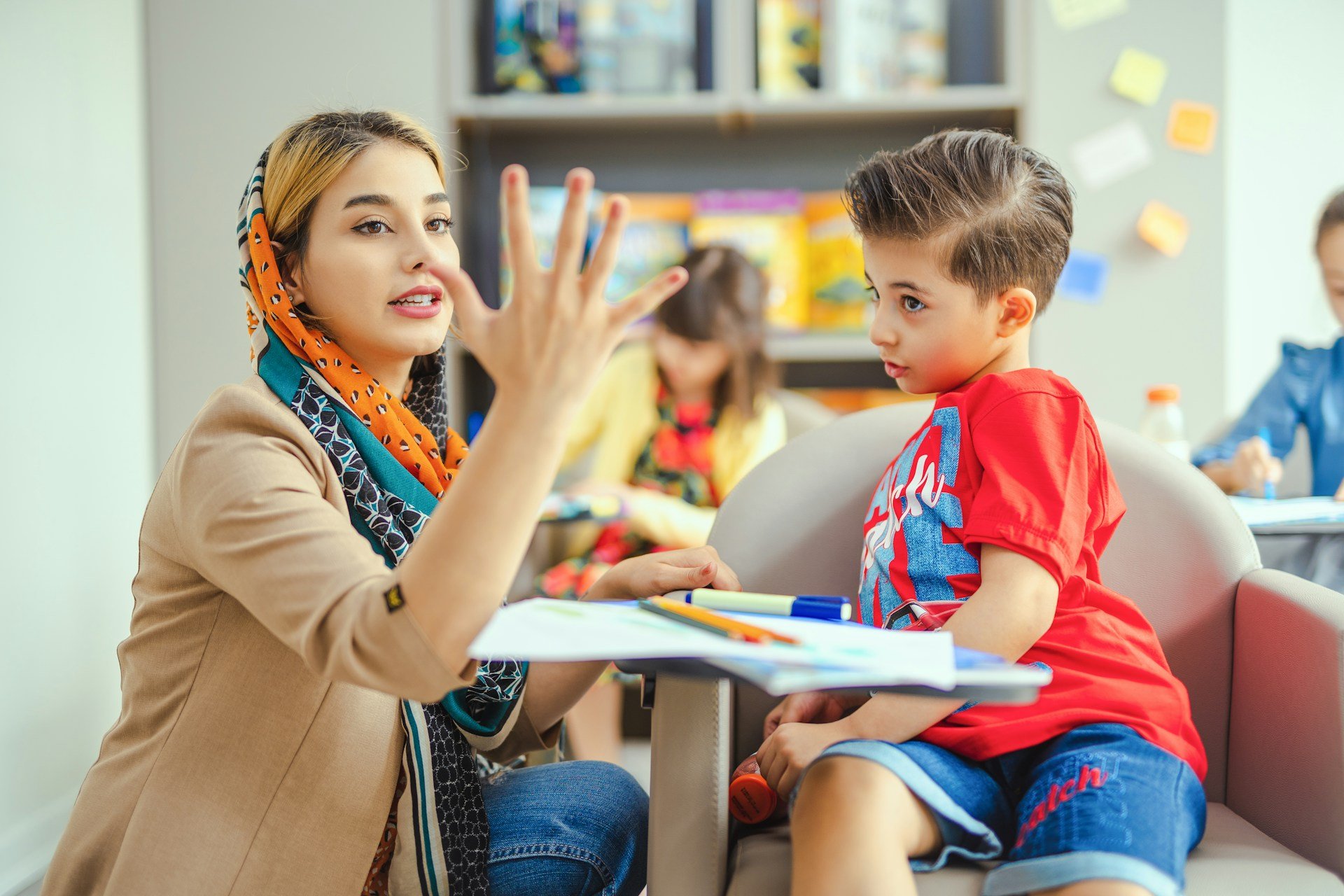 Speech pathologist on the Gold Coast guiding a young boy through a communication activity