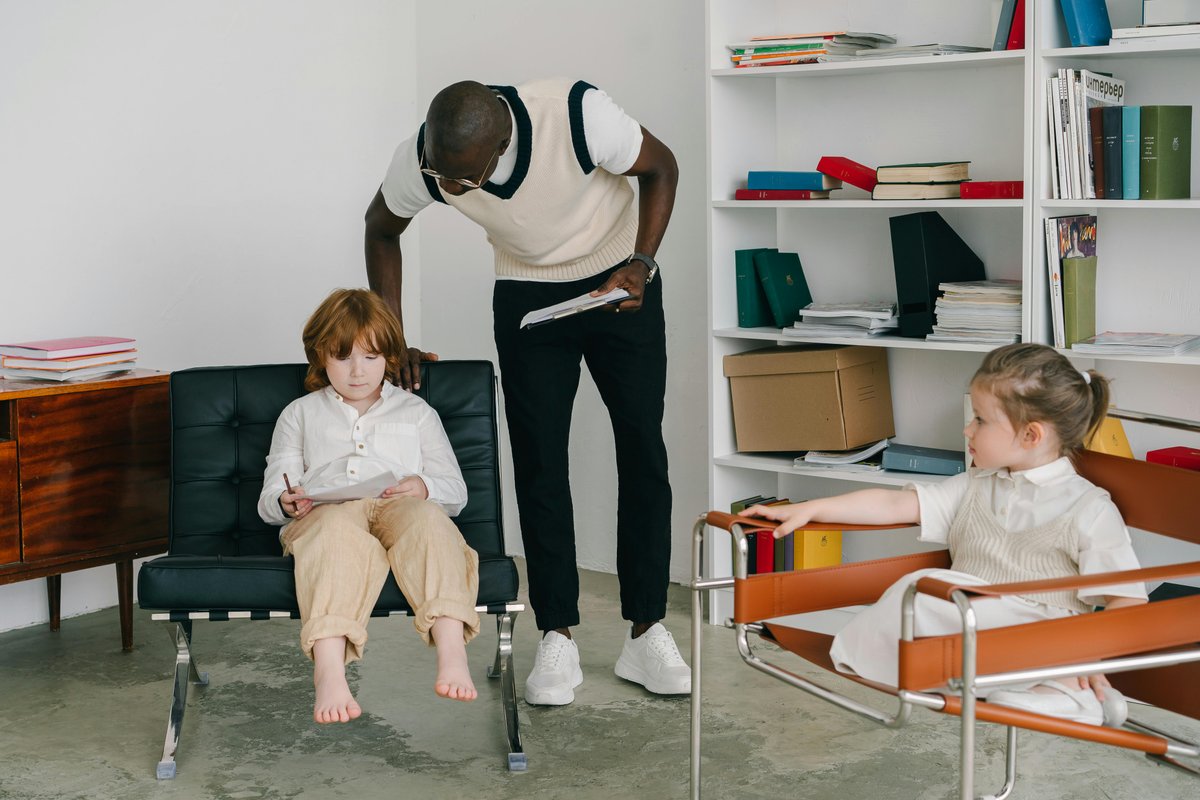 Occupational therapist engaging with children during autism therapy session